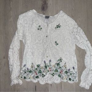 Crocheted sweater with clovers and flowers